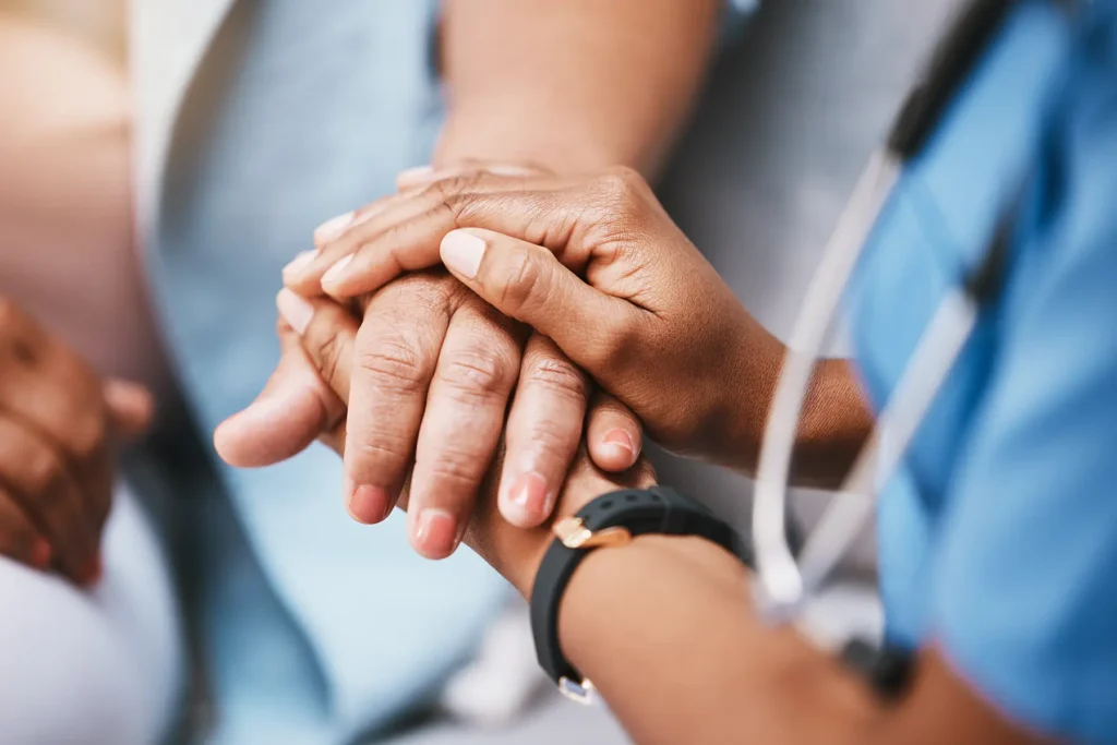 Empathy, trust and nurse holding hands with patient